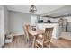 Cozy dining area with wood floors, natural light, and a view into the kitchen at 10521 Taylor Ave, Firestone, CO 80504
