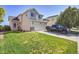 Charming two-story home with a well-maintained lawn and a long driveway with a truck parked on it at 10521 Taylor Ave, Firestone, CO 80504