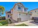 Charming two-story home with a well-maintained lawn, driveway, and a two-car garage at 10521 Taylor Ave, Firestone, CO 80504