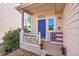Inviting front porch with a vibrant blue door, welcome sign, and decorative American flag at 10521 Taylor Ave, Firestone, CO 80504