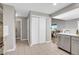 Hallway with tile flooring, closet, and view into the kitchen and living areas at 10521 Taylor Ave, Firestone, CO 80504