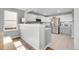 Open kitchen with white cabinets, stainless appliances, and plenty of counter space at 10521 Taylor Ave, Firestone, CO 80504