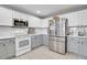 Well-equipped kitchen with stainless steel appliances and white subway tile backsplash at 10521 Taylor Ave, Firestone, CO 80504
