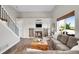 Inviting living room with a fireplace and barn-door details, bathed in natural light at 10521 Taylor Ave, Firestone, CO 80504