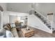 Comfortable living room featuring wood floors, staircase, and a cozy seating area at 10521 Taylor Ave, Firestone, CO 80504