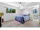 Bright bedroom featuring a ceiling fan, a window, and hardwood floors at 1121 Albion St # 210, Denver, CO 80220