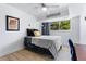 Cozy bedroom featuring a ceiling fan, a window, and hardwood floors at 1121 Albion St # 210, Denver, CO 80220