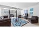 Open living room featuring comfortable seating, a modern area rug, and large windows for natural light at 1121 Albion St # 210, Denver, CO 80220