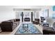 Bright living room with cozy sofas, a stylish rug, and natural light streaming through sliding glass doors at 1121 Albion St # 210, Denver, CO 80220