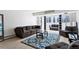 Inviting living space with ample seating, a decorative rug, and expansive windows for city views at 1121 Albion St # 210, Denver, CO 80220