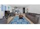 Comfortable living room with modern furniture, open kitchen access, and a vibrant area rug at 1121 Albion St # 210, Denver, CO 80220