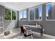 Bright office with large windows offering city views, modern desk and chair, and neutral decor at 1121 Albion St # 210, Denver, CO 80220