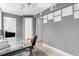 Modern office with glass desk, ladder bookshelf, and neutral colors at 1121 Albion St # 210, Denver, CO 80220