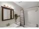 Cozy bathroom featuring tiled shower-tub, vanity, and decorative mirror with accent lighting at 519 Wright St # 108, Lakewood, CO 80228