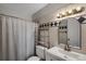 Bathroom with diamond-patterned tiles, a curtained shower, and a shelf unit at 519 Wright St # 108, Lakewood, CO 80228