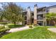 A well-maintained condo building with lovely green space and mature trees surrounding the property at 519 Wright St # 108, Lakewood, CO 80228