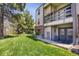 Exterior view of patio with chairs in grassy area of condo at 519 Wright St # 108, Lakewood, CO 80228