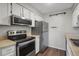A modest kitchen with stainless steel appliances, white cabinetry, and laminate countertops at 519 Wright St # 108, Lakewood, CO 80228