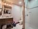 Bright bathroom features a wood vanity, neutral tile, and a glass-enclosed shower at 1401 Wewatta St # 308, Denver, CO 80202