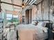 Bedroom with large windows, an industrial design, and a ceiling fan at 1401 Wewatta St # 308, Denver, CO 80202