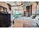 Comfortable bedroom with rustic wood wall, modern decor, and city views at 1401 Wewatta St # 308, Denver, CO 80202