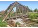 A historic metal bridge structure spans a waterway with natural landscaping at 1401 Wewatta St # 308, Denver, CO 80202