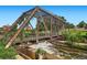 Scenic view of rustic pedestrian bridge with climbing vines and flowing river beneath at 1401 Wewatta St # 308, Denver, CO 80202