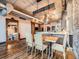 Open concept kitchen and dining area with exposed ductwork and beams at 1401 Wewatta St # 308, Denver, CO 80202