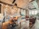 Open-concept living area with exposed brick, dining area, and comfortable seating at 1401 Wewatta St # 308, Denver, CO 80202