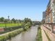 Scenic view of the river with adjacent buildings and greenery, perfect for leisurely strolls and enjoying nature at 1401 Wewatta St # 308, Denver, CO 80202