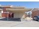 Well-lit carport with a parking spot adjacent to wooden privacy fence at 8746 Mariposa St, Thornton, CO 80260