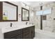 Bathroom with marble-style tile, and a double vanity at 3226 W Dakota Ave, Denver, CO 80219