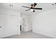 Spacious bedroom features a ceiling fan, white trim and walls, closet with sliding doors, and plush carpet at 3226 W Dakota Ave, Denver, CO 80219