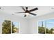 Bright bedroom featuring a modern ceiling fan, white walls and trim, and plenty of natural light from windows at 3226 W Dakota Ave, Denver, CO 80219
