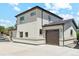 Home exterior features a tan stucco finish, dark trim, attached garage, and concrete driveway and sidewalks at 3226 W Dakota Ave, Denver, CO 80219