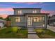 Charming exterior of home featuring a modern door, trimmed trees, and a lush green lawn at 3226 W Dakota Ave, Denver, CO 80219