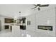 Open kitchen with stainless steel appliances, marble counters, and an adjacent fireplace at 3226 W Dakota Ave, Denver, CO 80219
