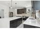 Bright kitchen with an island, stainless steel appliances, and marble countertops and backsplash at 3226 W Dakota Ave, Denver, CO 80219