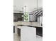 Modern kitchen with dark cabinets, an island, and updated appliances at 3226 W Dakota Ave, Denver, CO 80219