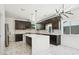Modern kitchen with stainless appliances, marble countertops and an island at 3226 W Dakota Ave, Denver, CO 80219