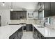 Modern kitchen sink with black fixtures, a marble countertop, and tile backsplash at 3226 W Dakota Ave, Denver, CO 80219