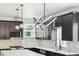 Stylish kitchen featuring dark cabinets, marble backsplash, and a quartz countertop island at 3226 W Dakota Ave, Denver, CO 80219
