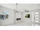 Bright, all-white living room with a modern fireplace and stylish light fixture at 3226 W Dakota Ave, Denver, CO 80219