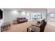 Spacious finished basement featuring two leather sofas, side tables, and recreation area with ping pong table at 14833 Vine St, Thornton, CO 80602