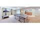 Basement game area with a ping pong table, treadmill, and view of the wet bar at 14833 Vine St, Thornton, CO 80602