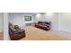 The basement living area features leather seating and a media setup, perfect for relaxing and entertaining at 14833 Vine St, Thornton, CO 80602