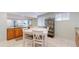 Basement kitchenette area has tiled floors, a dining table, and a connecting space with a game area at 14833 Vine St, Thornton, CO 80602