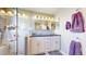 The updated bathroom features a double vanity, modern lighting, and a glass-enclosed walk-in shower at 14833 Vine St, Thornton, CO 80602