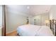 Bedroom features a bed, neutral paint, and closet storage with a view of the ping pong table at 14833 Vine St, Thornton, CO 80602