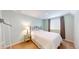 Bedroom features a bed, neutral paint, a bedside table, and dark curtains at 14833 Vine St, Thornton, CO 80602